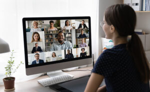 Woman watching webinar on desktop computer