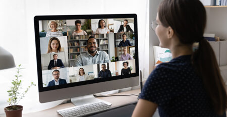 Woman watching webinar on desktop computer