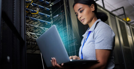 Woman working on laptop in backend office