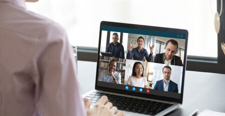 Someone watching a webinar on a laptop